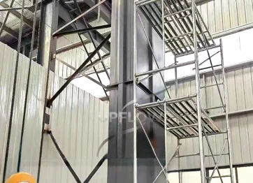 Enclosed chain bucket elevator with wear-resistant housing