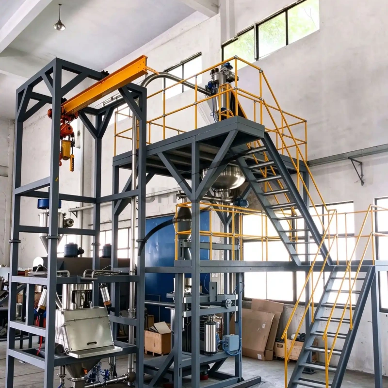 Powder feeding equipment on a steel platform with stairs and overhead hoist