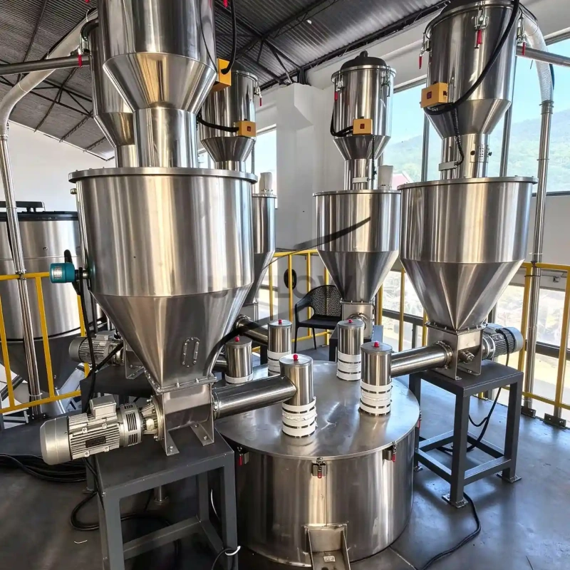 Stainless steel receivers above conical process hoppers with screw feeders